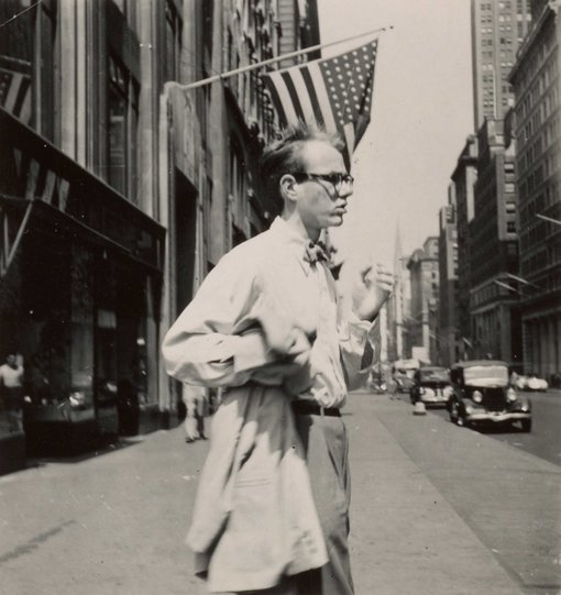 Photo of Andy Warhol on a city street. 