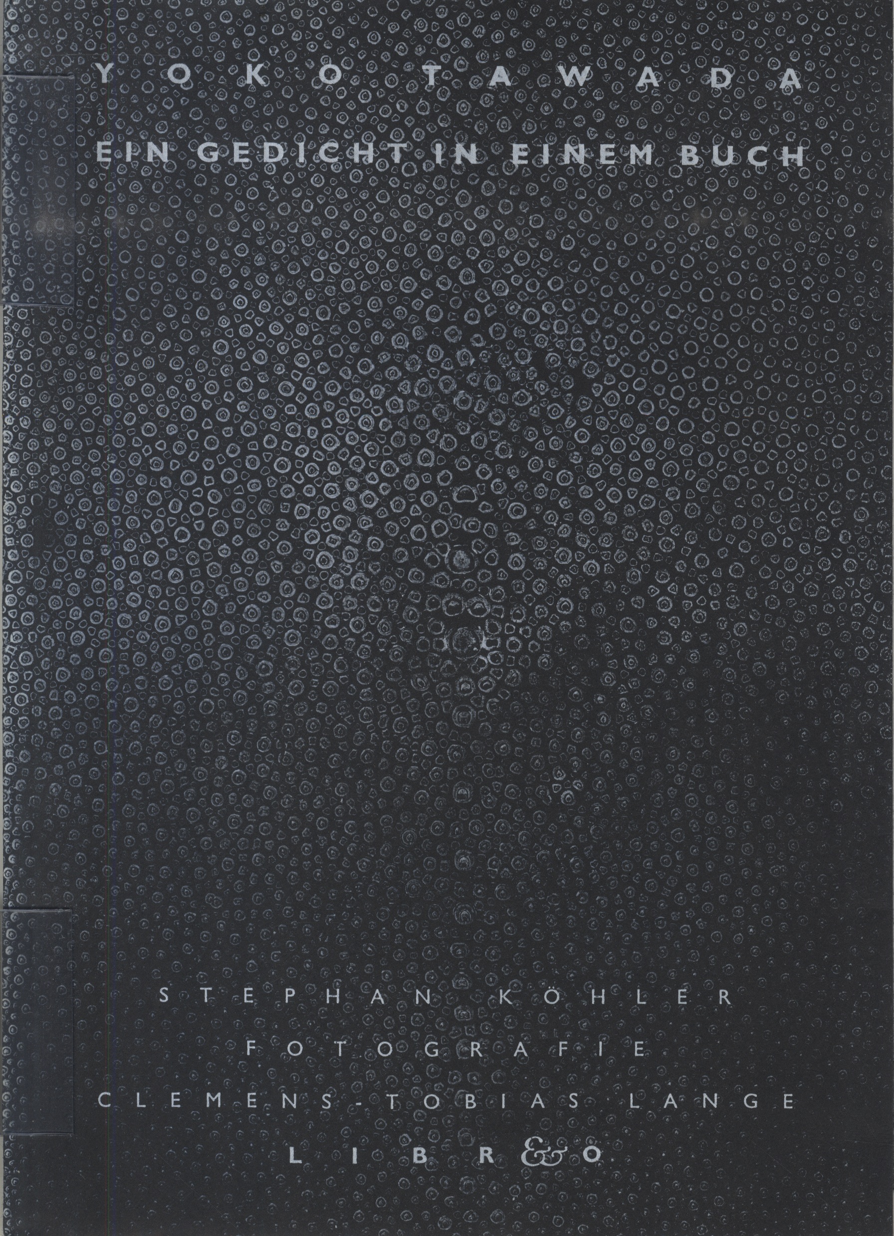 Black book cover with small circle pattern that look like dried water drops