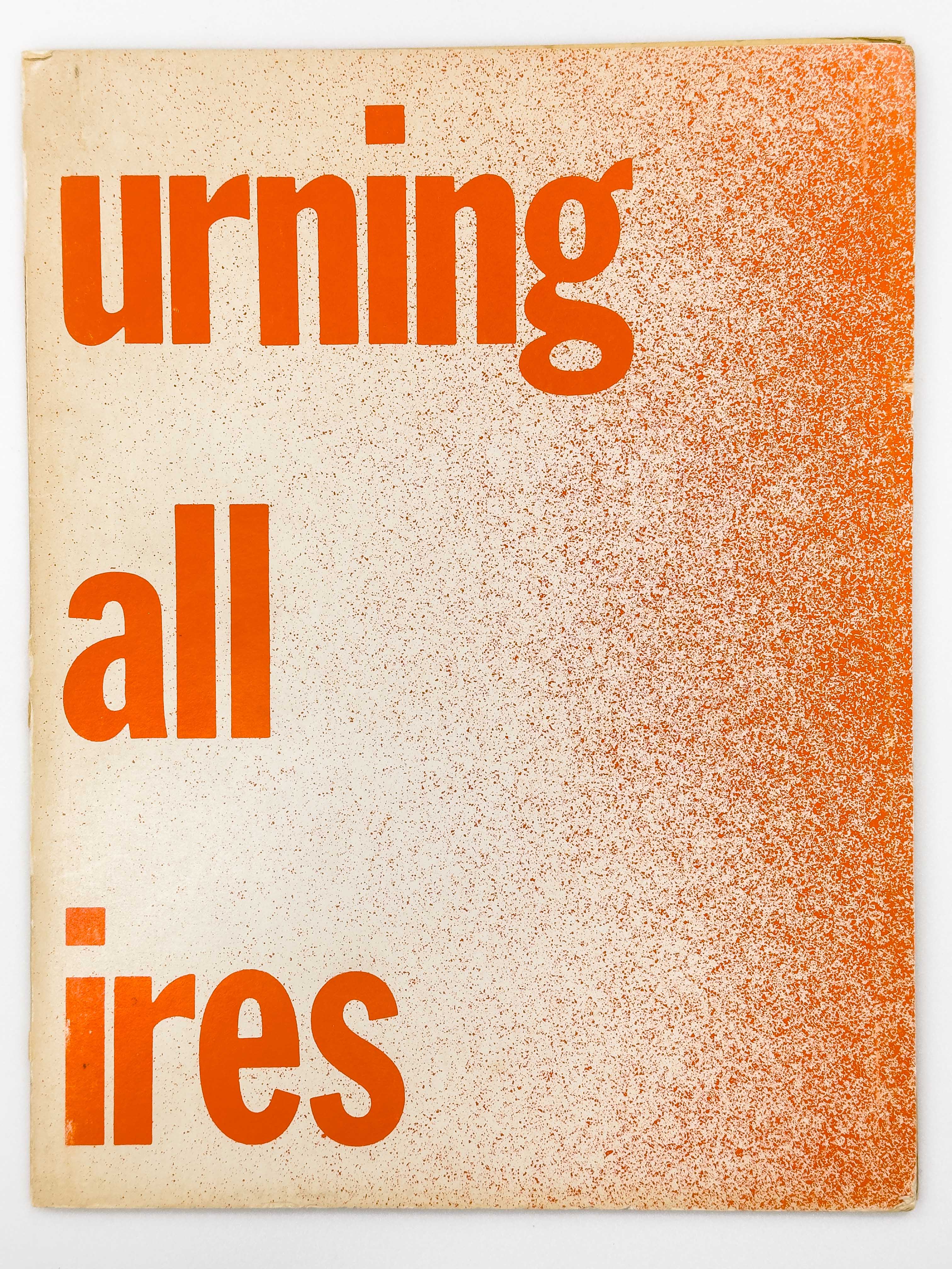 On an off-white background with a red grainy gradient coming from the right-hand hand side. There's big red text on the left-hand side that's split between the front and back cover, reading "Burning Small Fires."