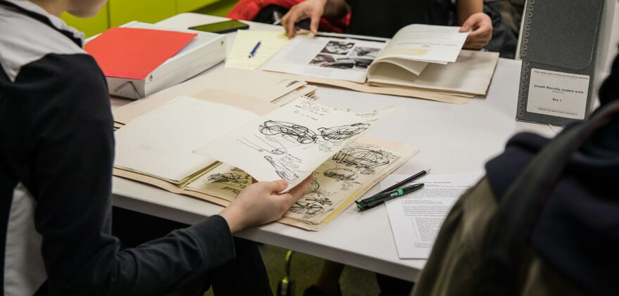 Researcher looking at archival materials in the archives office.