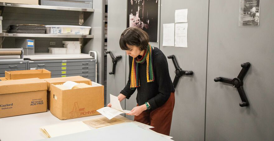 Archivist processing materials in the archives office.