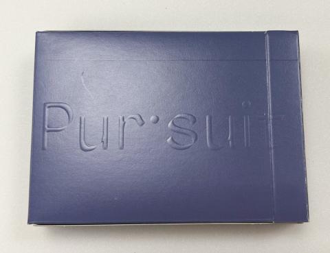 An embossed text, reading "Pur·suit" on a navy blue box. 